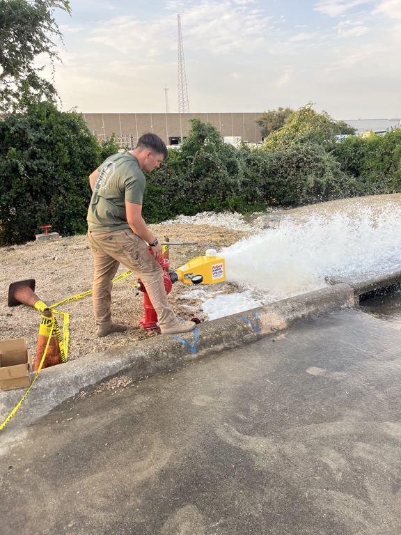 H2O technician performing a private fire hydrant flow test in Central Texas